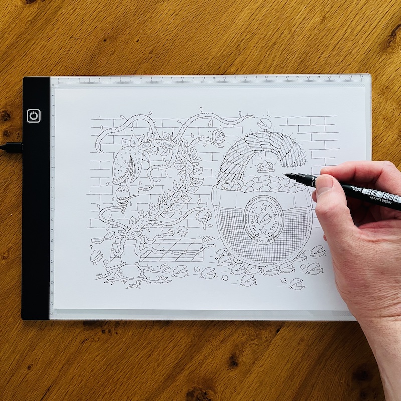 Step 2: Tracing the Pistachio Day drawing with ink pen onto paper using light box